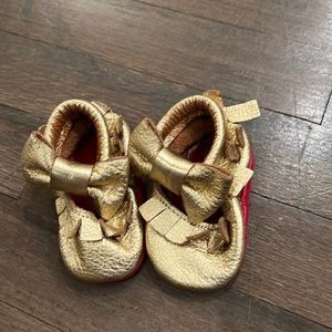 Gold mocassins with red bottoms size 2-3